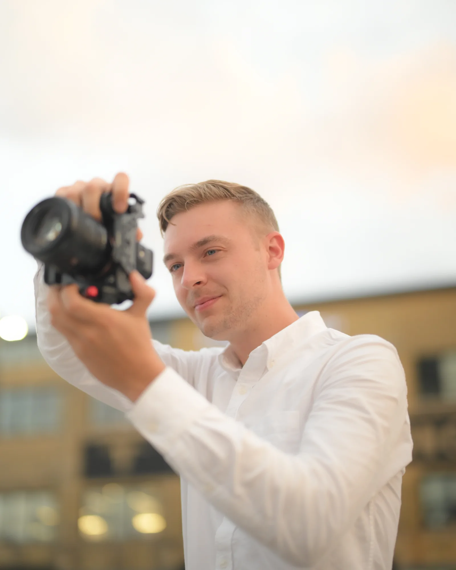 Luke Gelata shooting on location, camera raised