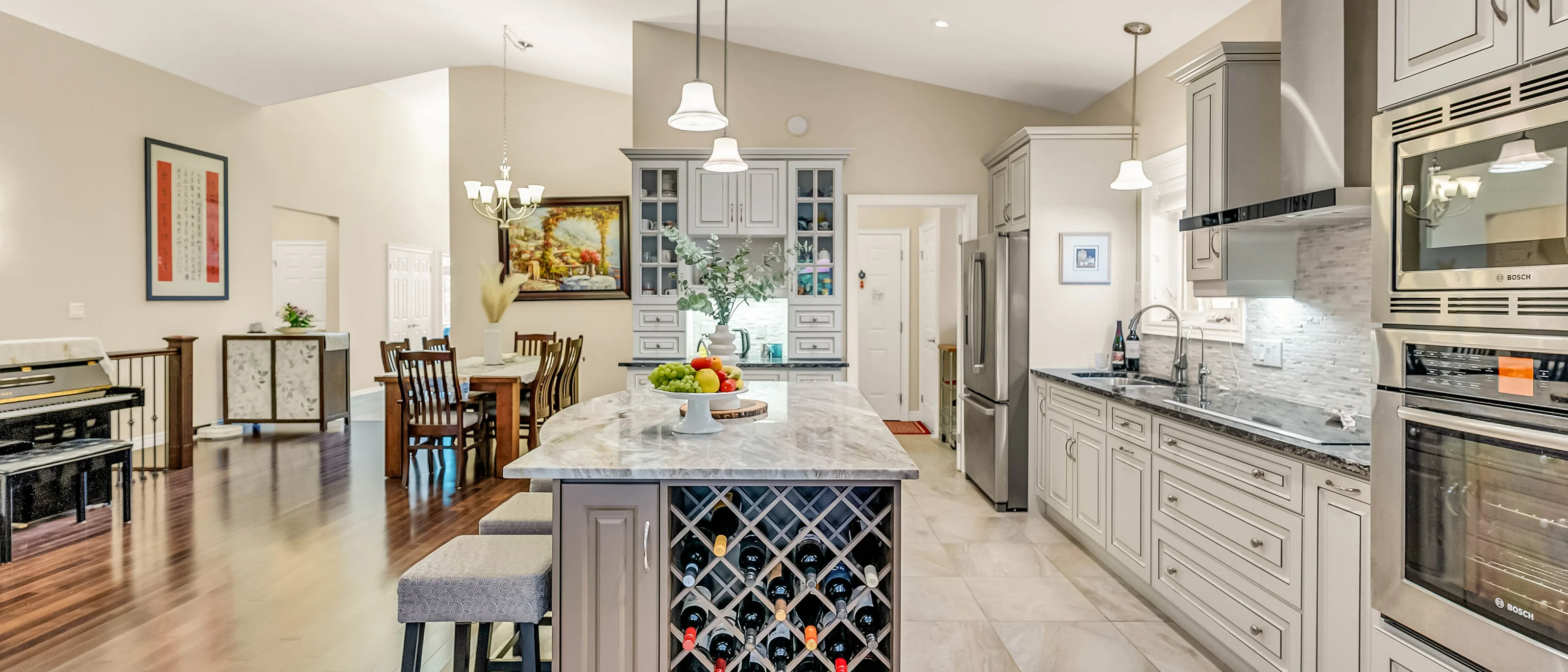 Kitchen island with a built-in wine rack and dining area beyond