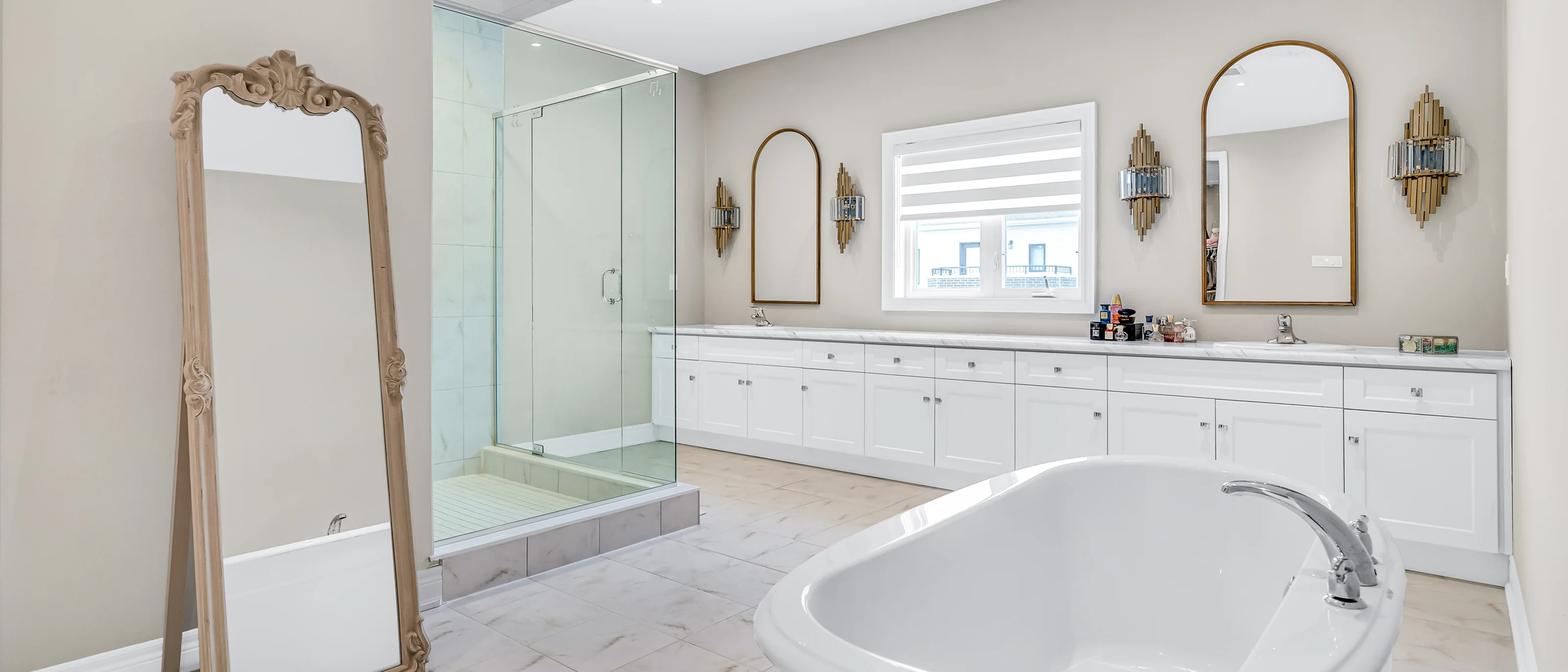 Ensuite bathroom with a soaker tub, glass shower and leaning mirror